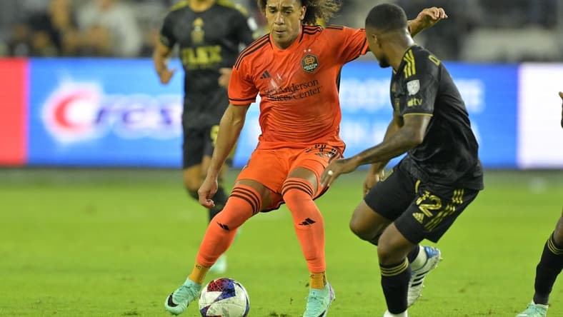 Dec 2, 2023; Los Angeles, California, USA; Houston Dynamo midfielder Adalberto Carrasquilla (20) kicks the ball past Los Angeles FC defender Diego Palacios (12) in the second half for the MLS Cup Western Conference Final at BMO Stadium. Mandatory Credit: Jayne Kamin-Oncea-USA TODAY Sports