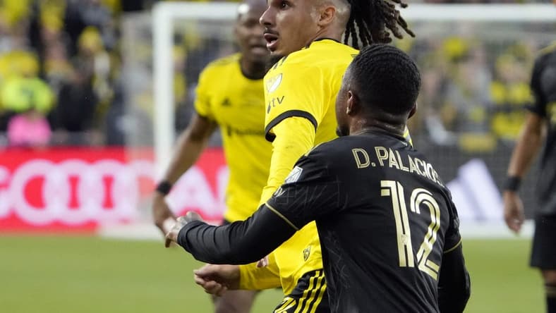 Dec 9, 2023; Columbus, OH, USA; Columbus Crew defender Mohamed Farsi (23) battles for the ball against Los Angeles FC defender Diego Palacios (12) in the first half during 2023 MLS CUP at Lower.com Field.