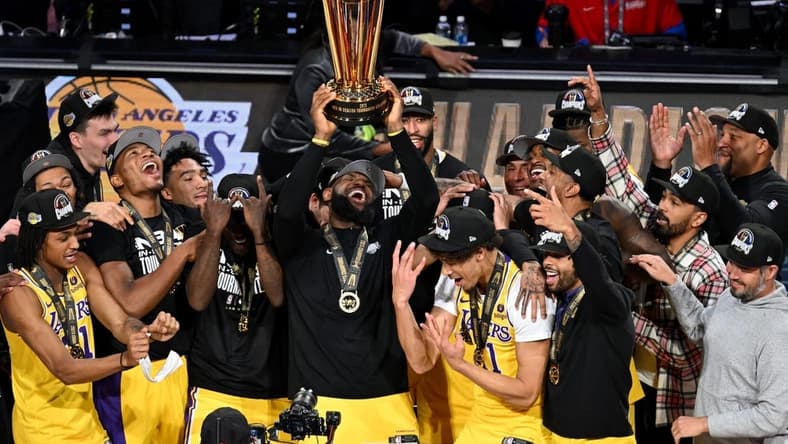 Dec 9, 2023; Las Vegas, Nevada, USA; Los Angeles Lakers forward LeBron James (23) hoists the NBA Cup and celebrates with teammates after winning the NBA In-Season Tournament Championship game against the Indiana Pacers at T-Mobile Arena. Mandatory Credit: Candice Ward-USA TODAY Sports