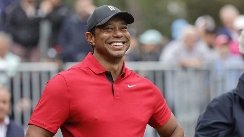 Dec 17, 2023; Orlando, Florida, USA;  Tiger Woods smiles before he plays his shot from the first tee during the PNC Championship at The Ritz-Carlton Golf Club. Mandatory Credit: Reinhold Matay-USA TODAY Sports