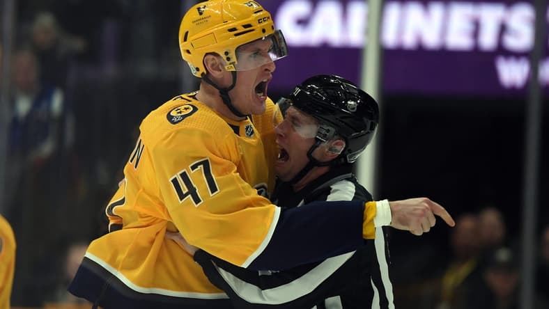 Dec 19, 2023; Nashville, Tennessee, USA; Nashville Predators right wing Michael McCarron (47) is held back by linesman Libor Suchanek (60) before receiving a game misconduct during the first period against the Vancouver Canucks at Bridgestone Arena. Mandatory Credit: Christopher Hanewinckel-USA TODAY Sports