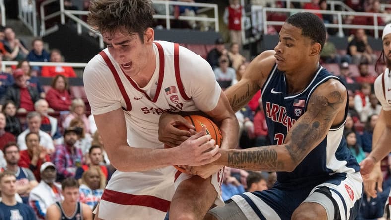 Dec 31, 2023; Stanford, California, USA; Stanford Cardinal forward Maxime Raynaud (42) and Arizona Wildcats forward Keshad Johnson (16) fight for control of the ball during the second half at Maples Pavilion. Mandatory Credit: Stan Szeto-USA TODAY Sports