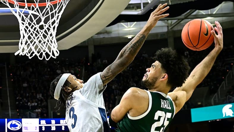 Jan 4, 2024; East Lansing, Michigan, USA; Michigan State Spartans forward Malik Hall (25) slams the ball home against Penn State Nittany Lions guard Nick Kern Jr. (3) during the second half at Jack Breslin Student Events Center. Mandatory Credit: Dale Young-USA TODAY Sports