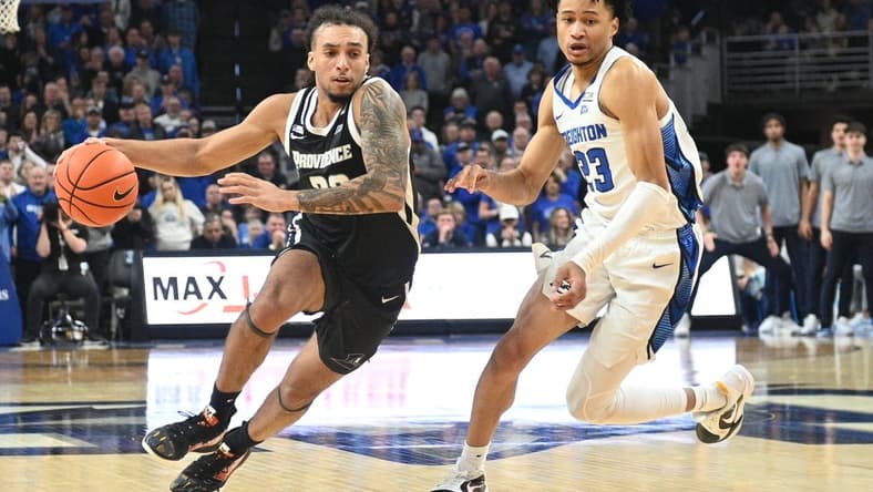 Jan 6, 2024; Omaha, Nebraska, USA; Providence Friars guard Devin Carter (22) drives against Creighton Bluejays guard Trey Alexander (23) in the second half at CHI Health Center Omaha. Mandatory Credit: Steven Branscombe-USA TODAY Sports
