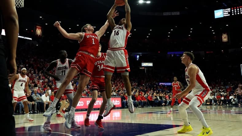 Jan 6, 2024; Tucson, Arizona, USA; Arizona Wildcats forward Keshad Johnson (16) grabs a rebound against Utah Utes forward Ben Carlson (1) during the first half at McKale Center. Mandatory Credit: Zachary BonDurant-USA TODAY Sports