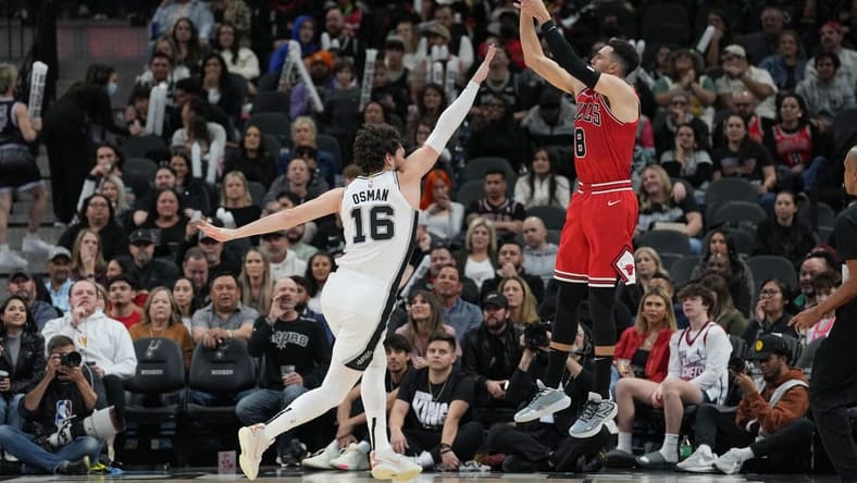 Jan 13, 2024; San Antonio, Texas, USA;  Chicago Bulls guard Zach LaVine (8) shoots over San Antonio Spurs forward Cedi Osman (16) in the second half at Frost Bank Center. Mandatory Credit: Daniel Dunn-USA TODAY Sports