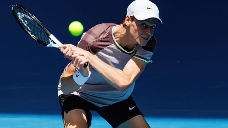 Jan 14, 2024; Melbourne, Victoria, Australia; Jannik Sinner of Italy hits a shot against Botic Van De Zandschulp of the Netherlands in the first round of the men s singles. Mandatory Credit: Mike Frey-USA TODAY Sports