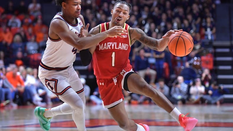 Jan 14, 2024; Champaign, Illinois, USA;  Maryland guard Jahmir Young (1) drives the ball against Illinois center Braden Pierce (4) during the second half at State Farm Center. Mandatory Credit: Ron Johnson-USA TODAY Sports