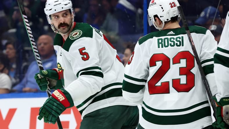 Jan 18, 2024; Tampa, Florida, USA; Minnesota Wild defenseman Jake Middleton (5) is congratulated after scoring against the Tampa Bay Lightning during the second period at Amalie Arena. Mandatory Credit: Kim Klement Neitzel-USA TODAY Sports