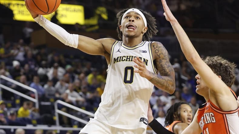 Jan 18, 2024; Ann Arbor, Michigan, USA;  Michigan Wolverines guard Dug McDaniel (0) shoots on Illinois Fighting Illini guard Niccolo Moretti (11) in the first half at Crisler Center. Mandatory Credit: Rick Osentoski-USA TODAY Sports