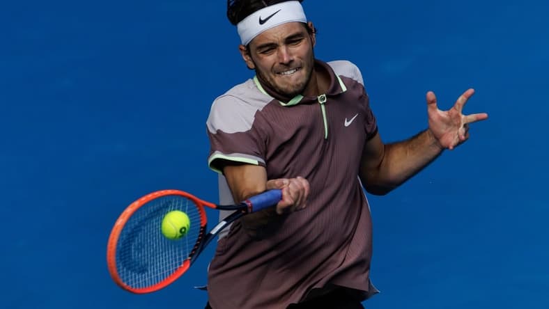Jan 23, 2024; Melbourne, Victoria, Australia;
Taylor Fritz of the United States in action against Novak Djokovic of Serbia in the quarter final of the men s singles. Mandatory Credit: Mike Frey-USA TODAY Sports