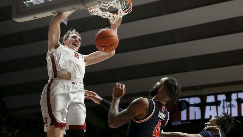 Jan 24, 2024; Tuscaloosa, Alabama, USA; Alabama Crimson Tide forward Grant Nelson (2) makes a dunk late in the game over Auburn Tigers center Johni Broome (4) at Coleman Coliseum. Mandatory Credit: Gary Cosby Jr.-USA TODAY Sports