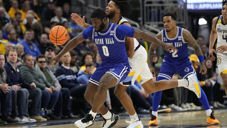 Jan 27, 2024; Milwaukee, Wisconsin, USA; Seton Hall Pirates guard Dylan Addae-Wusu (0) and Marquette Golden Eagles forward David Joplin (23) chase the loose ball during the second half at Fiserv Forum. Mandatory Credit: Jeff Hanisch-USA TODAY Sports