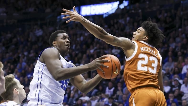 Jan 27, 2024; Provo, Utah, USA; Brigham Young Cougars forward Fousseyni Traore (45) drives to the basket against Texas Longhorns forward Dillon Mitchell (23) during the second half at Marriott Center. Mandatory Credit: Rob Gray-USA TODAY Sports