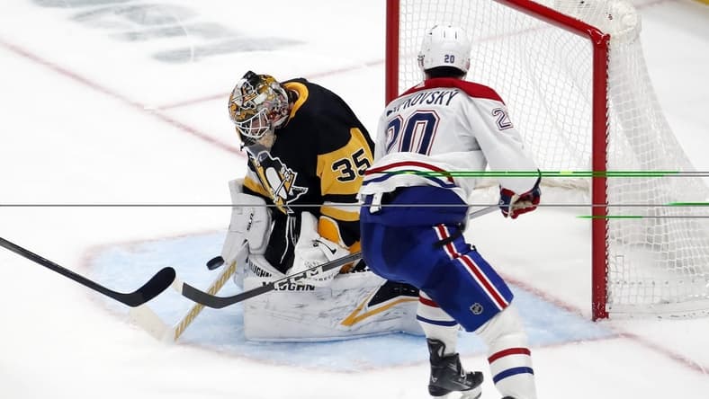 Jan 27, 2024; Pittsburgh, Pennsylvania, USA; Pittsburgh Penguins goaltender Tristan Jarry (35) makes a save against Montreal Canadiens left wing Juraj Slafkovsky (20) in overtime at PPG Paints Arena. The Penguins won 3-2 in overtime. Mandatory Credit: Charles LeClaire-USA TODAY Sports