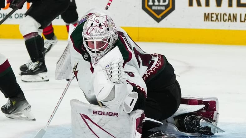Jan 27, 2024; Raleigh, North Carolina, USA; Arizona Coyotes goaltender Connor Ingram (39) makes a glove save against the Carolina Hurricanes during the third period at PNC Arena. Mandatory Credit: James Guillory-USA TODAY Sports