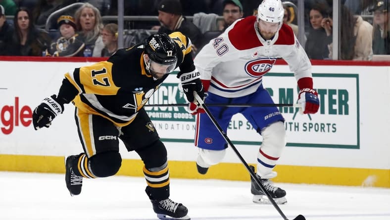 Jan 27, 2024; Pittsburgh, Pennsylvania, USA; Pittsburgh Penguins right wing Bryan Rust (17) breaks up ice with the puck as Montreal Canadiens right wing Joel Armia (40) chases during the third period at PPG Paints Arena. The Penguins won 3-2 in overtime. Mandatory Credit: Charles LeClaire-USA TODAY Sports