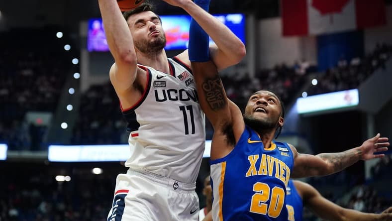 Jan 28, 2024; Hartford, Connecticut, USA; UConn Huskies forward Alex Karaban (11) works for the rebound against Xavier Musketeers guard Dayvion McKnight (20) in the first half at XL Center. Mandatory Credit: David Butler II-USA TODAY Sports