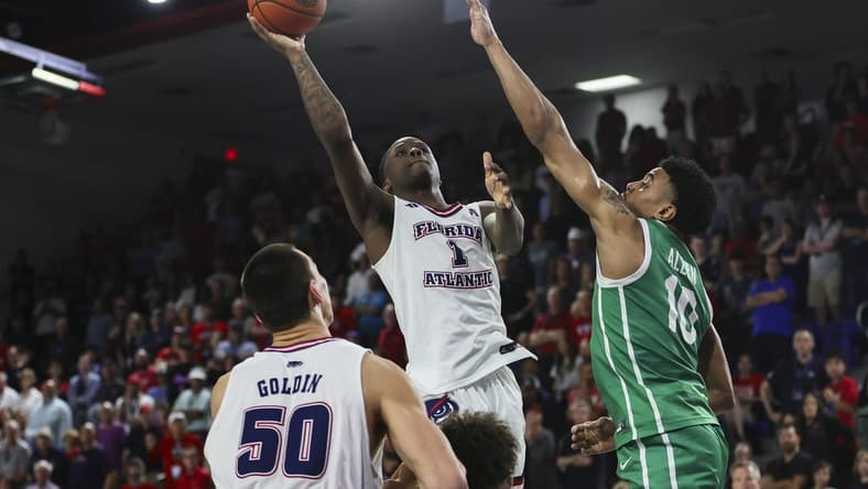 Jan 28, 2024; Boca Raton, Florida, USA; Florida Atlantic Owls guard Johnell Davis (1) shoots the basketball over North Texas Mean Green forward Robert Allen (10) during the second half at Eleanor R. Baldwin Arena. Mandatory Credit: Sam Navarro-USA TODAY Sports