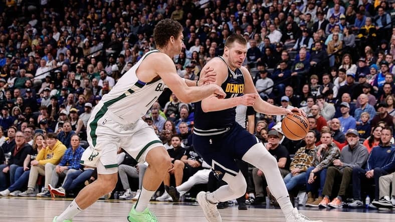 Jan 29, 2024; Denver, Colorado, USA; Denver Nuggets center Nikola Jokic (15) controls the ball against Milwaukee Bucks center Brook Lopez (11) in the fourth quarter at Ball Arena. Mandatory Credit: Isaiah J. Downing-USA TODAY Sports
