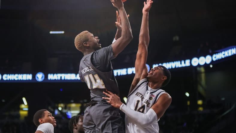 Jan 9, 2024; Atlanta, Georgia, USA; Georgia Tech Yellow Jackets guard Kowacie Reeves Jr. (14) shoots over Notre Dame Fighting Irish forward Kebba Njie (14) in the second half at McCamish Pavilion. Mandatory Credit: Brett Davis-USA TODAY Sports