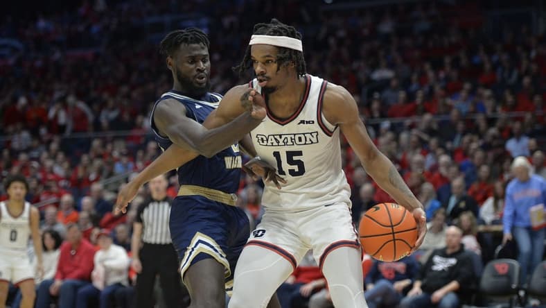 Jan 30, 2024; Dayton, Ohio, USA;  Dayton Flyers forward DaRon Holmes II (15) drives to the basket against George Washington center Babatunde Akingbola (23) during a game at University of Dayton Arena. Mandatory Credit: Matt Lunsford-USA TODAY Sports