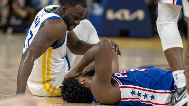Jan 30, 2024; San Francisco, California, USA; Golden State Warriors forward Draymond Green (23) checks on Philadelphia 76ers center Joel Embiid (21) after a play during the second quarter at Chase Center. Mandatory Credit: Neville E. Guard-USA TODAY Sports