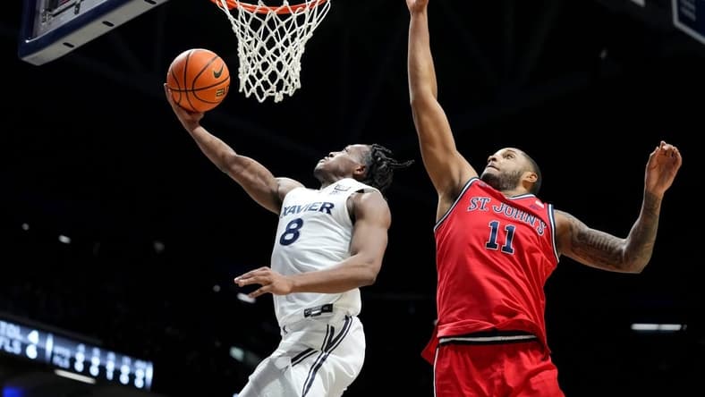 Xavier Musketeers guard Quincy Olivari (8) scores at the basket in the first half of a college basketball game between the St. John's Red Storm and the Xavier Musketeers, Wednesday, Jan. 31, 2024, at Cintas Center in Cincinnati.