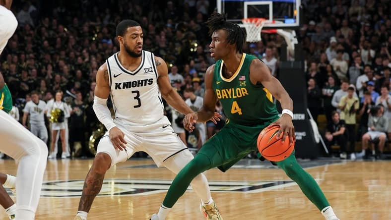 Jan 31, 2024; Orlando, Florida, USA; UCF Knights guard Darius Johnson (3) defends Baylor Bears guard Ja'Kobe Walter (4) during the first half at Addition Financial Arena. Mandatory Credit: Mike Watters-USA TODAY Sports