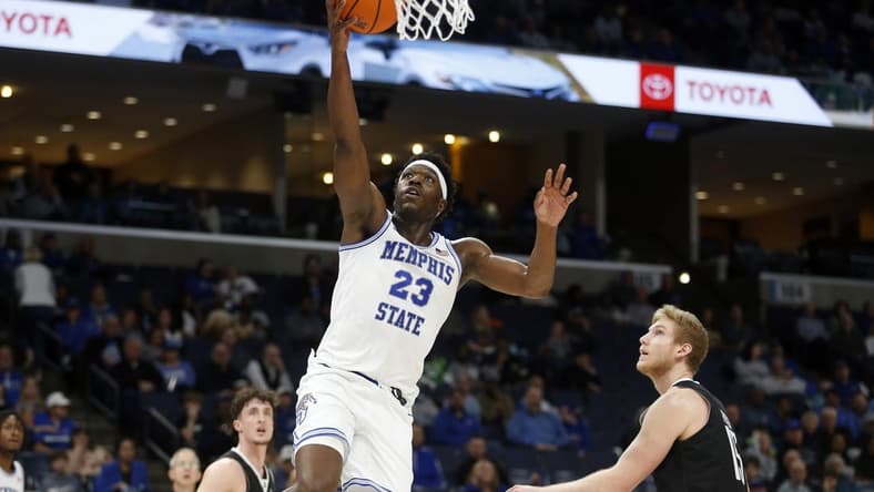 Jan 31, 2024; Memphis, Tennessee, USA; Memphis Tigers forward Malcolm Dandridge (23) drives to the basket as Rice Owls forward Max Fiedler (15) defends during the first half at FedExForum. Mandatory Credit: Petre Thomas-USA TODAY Sports