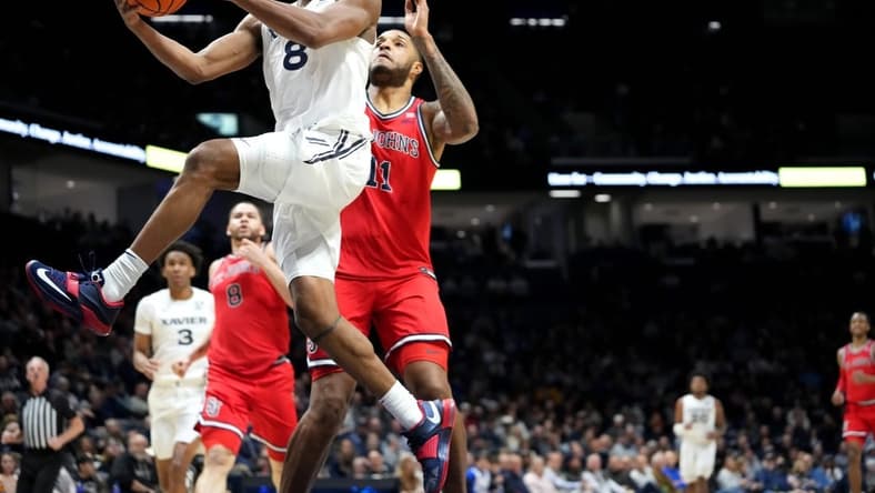 Xavier Musketeers guard Quincy Olivari (8) scores at the basket in the first half of a college basketball game between the St. John's Red Storm and the Xavier Musketeers, Wednesday, Jan. 31, 2024, at Cintas Center in Cincinnati.