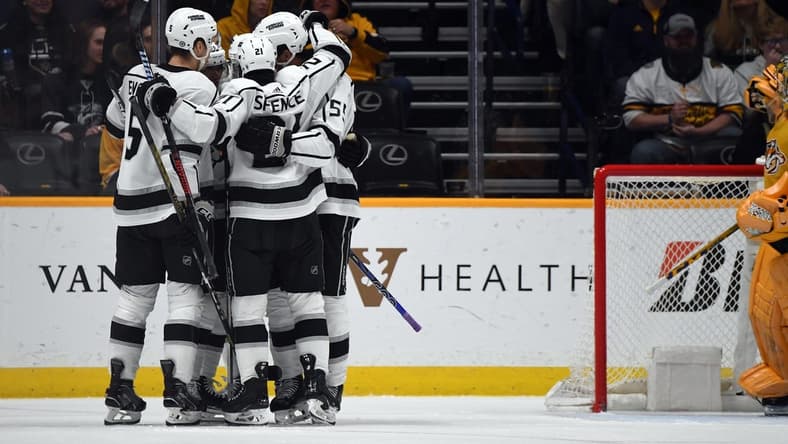 Jan 31, 2024; Nashville, Tennessee, USA; Los Angeles Kings players celebrate after a goal by center Trevor Lewis (61) during the third period against the Nashville Predators at Bridgestone Arena. Mandatory Credit: Christopher Hanewinckel-USA TODAY Sports
