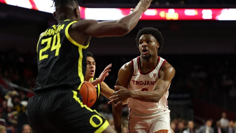 Feb 1, 2024; Los Angeles, California, USA; USC Trojans guard Bronny James (6) passes the ball against Oregon Ducks forward Mahamadou Diawara (24) during the first half at Galen Center. Mandatory Credit: Kiyoshi Mio-USA TODAY Sports