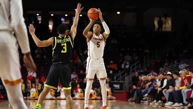Feb 1, 2024; Los Angeles, California, USA; USC Trojans guard Boogie Ellis (5) shoots the ball over Oregon Ducks guard Jackson Shelstad (3) during the first half at Galen Center. Mandatory Credit: Kiyoshi Mio-USA TODAY Sports