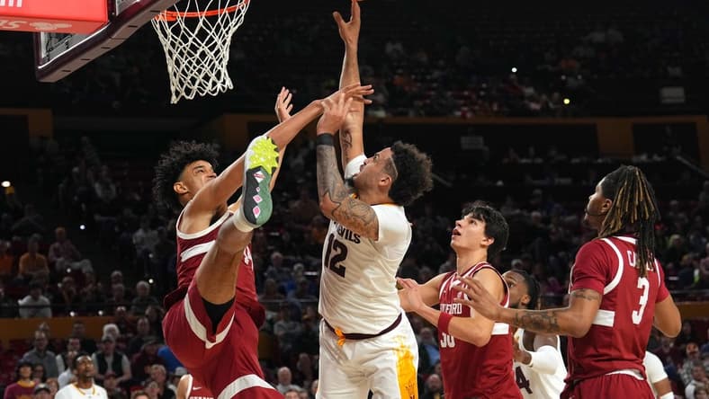 Feb 1, 2024; Tempe, Arizona, USA; Arizona State Sun Devils guard Jose Perez (12) shoots over Stanford Cardinal forward Spencer Jones (14) during the second half at Desert Financial Arena. Mandatory Credit: Joe Camporeale-USA TODAY Sports
