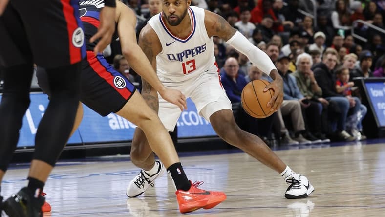 Feb 2, 2024; Detroit, Michigan, USA; LA Clippers forward Paul George (13) dribbles defended by Detroit Pistons guard Cade Cunningham (2) in the first half at Little Caesars Arena. Mandatory Credit: Rick Osentoski-USA TODAY Sports