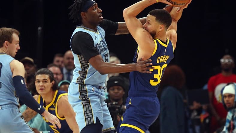Feb 2, 2024; Memphis, Tennessee, USA; Golden State Warriors guard Stephen Curry (30) handles the ball as Memphis Grizzlies guard Vince Williams Jr. (5) defends during the first half at FedExForum. Mandatory Credit: Petre Thomas-USA TODAY Sports