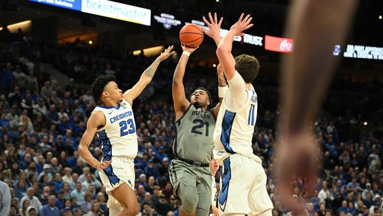 Feb 2, 2024; Omaha, Nebraska, USA; Butler Bulldogs guard Pierre Brooks (21) shoots over Creighton Bluejays guard Trey Alexander (23) and center Ryan Kalkbrenner (11) in the first half at CHI Health Center Omaha. Mandatory Credit: Steven Branscombe-USA TODAY Sports