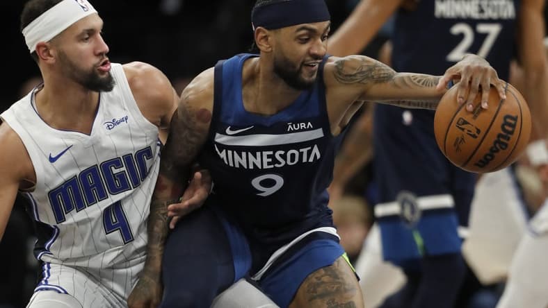 Feb 2, 2024; Minneapolis, Minnesota, USA; Minnesota Timberwolves guard Nickeil Alexander-Walker (9) works around Orlando Magic guard Jalen Suggs (4) in the fourth quarter at Target Center. Mandatory Credit: Bruce Kluckhohn-USA TODAY Sports