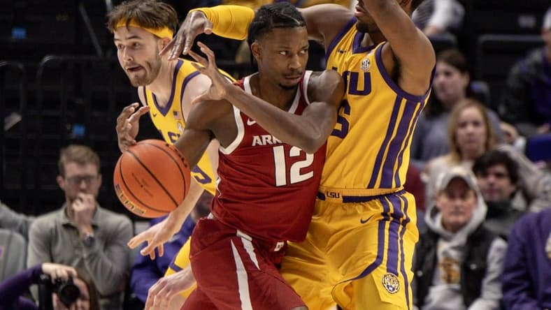 Feb 3, 2024; Baton Rouge, Louisiana, USA;  Arkansas Razorbacks guard Tramon Mark (12) dribbles into LSU Tigers guard Jordan Wright (6) to get to the basket during the first half at Pete Maravich Assembly Center. Mandatory Credit: Stephen Lew-USA TODAY Sports