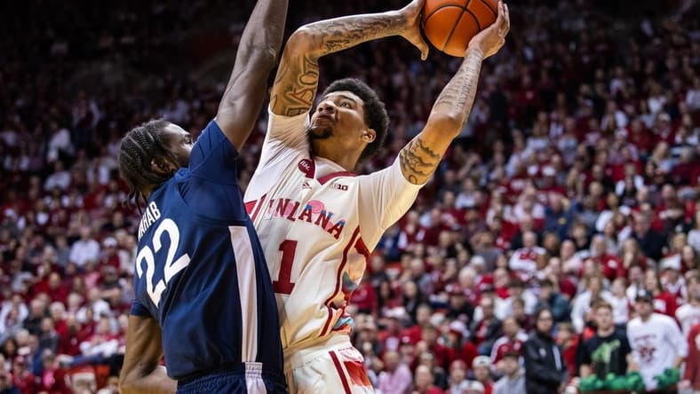 Feb 3, 2024; Bloomington, Indiana, USA; Indiana Hoosiers center Kel'el Ware (1) shoots the ball while Penn State Nittany Lions forward Qudus Wahab (22) defends in the first half at Simon Skjodt Assembly Hall. Mandatory Credit: Trevor Ruszkowski-USA TODAY Sports