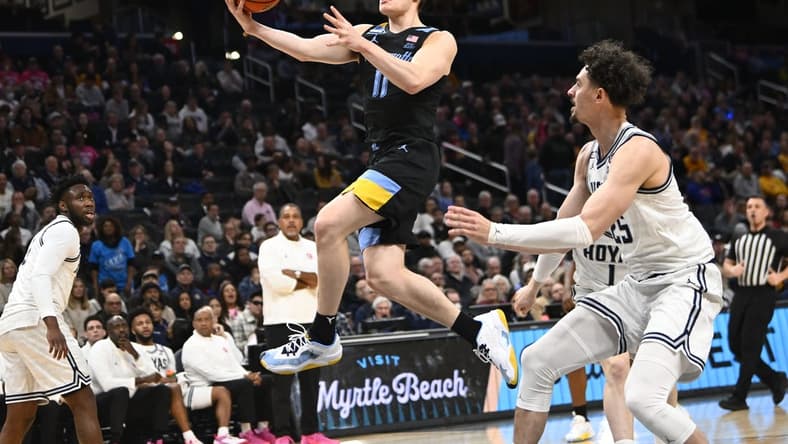 Feb 3, 2024; Washington, District of Columbia, USA; Marquette Golden Eagles guard Tyler Kolek (11) shoots past Georgetown Hoyas forward Ismael Massoud (25) during the first half at Capital One Arena. Mandatory Credit: Brad Mills-USA TODAY Sports