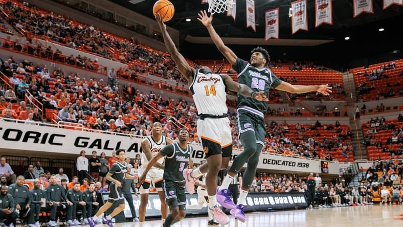 Feb 3, 2024; Stillwater, Oklahoma, USA; Oklahoma State Cowboys guard Jamyron Keller (14) shoots the ball around Kansas State Wildcats forward Jerrell Colbert (20) during the first half at Gallagher-Iba Arena. Mandatory Credit: William Purnell-USA TODAY Sports
