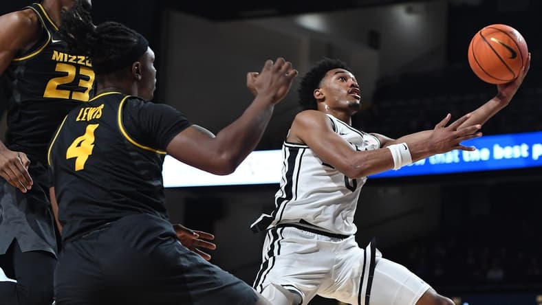 Feb 3, 2024; Nashville, Tennessee, USA; Vanderbilt Commodores guard Tyrin Lawrence (0) scores past Missouri Tigers forward Aidan Shaw (23) and guard Curt Lewis (4) during the first half at Memorial Gymnasium. Mandatory Credit: Christopher Hanewinckel-USA TODAY Sports