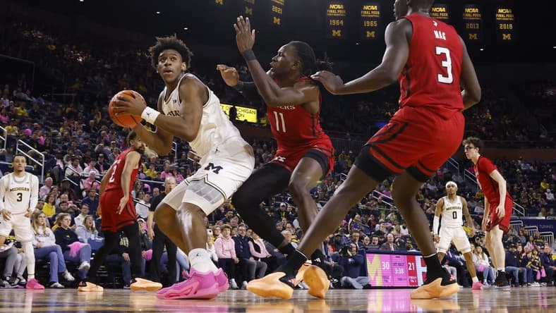 Feb 3, 2024; Ann Arbor, Michigan, USA; Michigan Wolverines forward Tarris Reed Jr. (32) is defended by Rutgers Scarlet Knights center Clifford Omoruyi (11) in the first half at Crisler Center. Mandatory Credit: Rick Osentoski-USA TODAY Sports