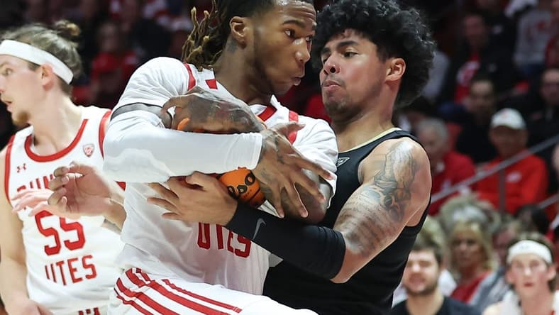 Feb 3, 2024; Salt Lake City, Utah, USA; Utah Utes guard Deivon Smith (5) and Colorado Buffaloes guard Julian Hammond III (3) battle for the ball during the first half at Jon M. Huntsman Center. Mandatory Credit: Rob Gray-USA TODAY Sports
