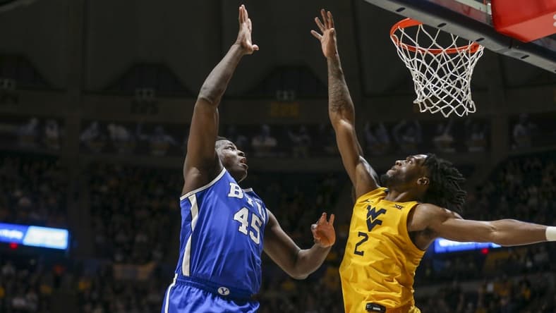 Feb 3, 2024; Morgantown, West Virginia, USA; Brigham Young Cougars forward Fousseyni Traore (45) shoots over West Virginia Mountaineers guard Kobe Johnson (2) during the first half at WVU Coliseum. Mandatory Credit: Ben Queen-USA TODAY Sports