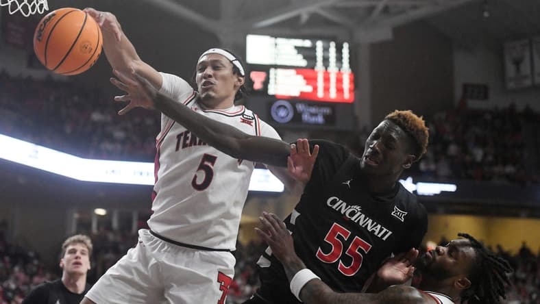 Texas Tech's guard Darrion Williams (5) and Cincinnati's forward Aziz Bandaogo (55) reach for the ball during the Big 12 basketball game, Saturday, Feb. 3, 2024, at United Supermarkets Arena.