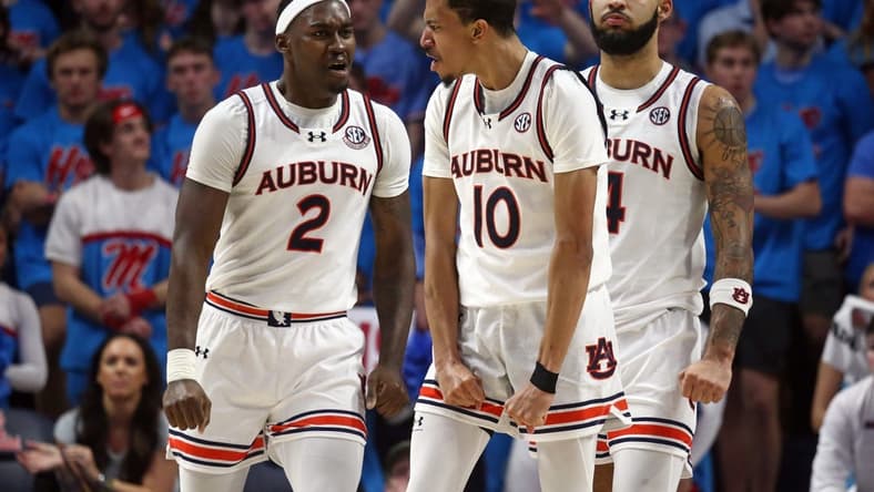 Feb 3, 2024; Oxford, Mississippi, USA; Auburn Tigers guard/forward Chad Baker-Mazara (10) reacts with forward Jaylin Williams (2) and forward/center Johni Broome (4) after a dunk during the second half against the Mississippi Rebels at The Sandy and John Black Pavilion at Ole Miss. Mandatory Credit: Petre Thomas-USA TODAY Sports