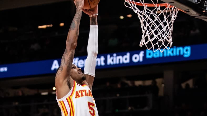 Feb 3, 2024; Atlanta, Georgia, USA; Atlanta Hawks guard Dejounte Murray (5) dunks against Golden State Warriors during the first quarter at State Farm Arena. Mandatory Credit: Jordan Godfree-USA TODAY Sports